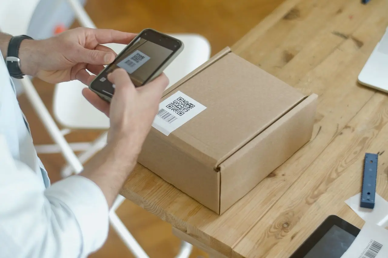 Prep centre technician verifying packaging and barcode labels against manifest